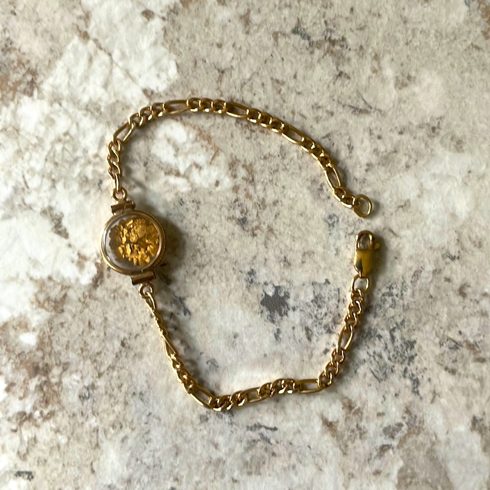 Gold plated bracelet with gold chips inside the circle…
Price Firm